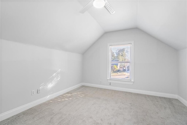 additional living space featuring ceiling fan, light carpet, and vaulted ceiling