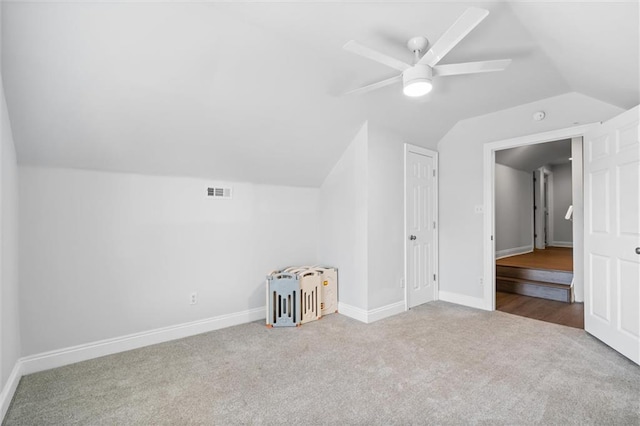 additional living space featuring carpet flooring, ceiling fan, and vaulted ceiling