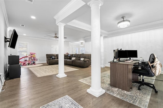 home office with hardwood / wood-style flooring, ceiling fan, crown molding, and decorative columns