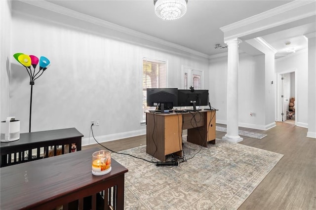 office with ornate columns, crown molding, wood-type flooring, and a notable chandelier