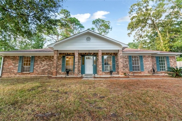 ranch-style home featuring a porch and a front yard