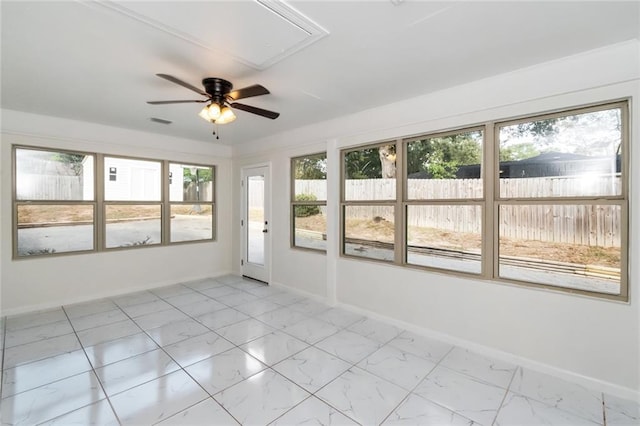 unfurnished sunroom with a wealth of natural light and ceiling fan