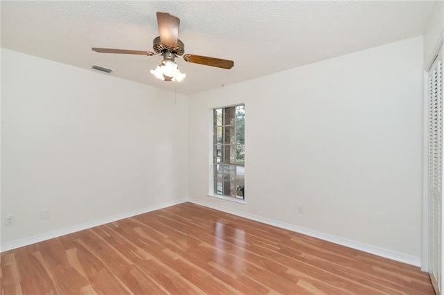 spare room featuring ceiling fan, a textured ceiling, and light hardwood / wood-style floors