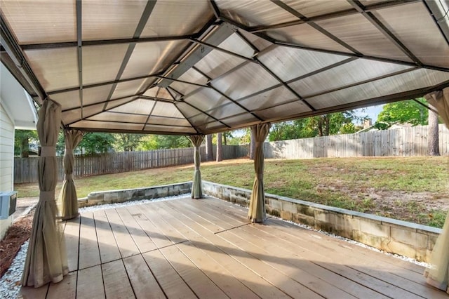 wooden terrace featuring a yard and a gazebo