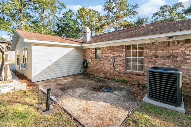 rear view of property with central air condition unit and cooling unit