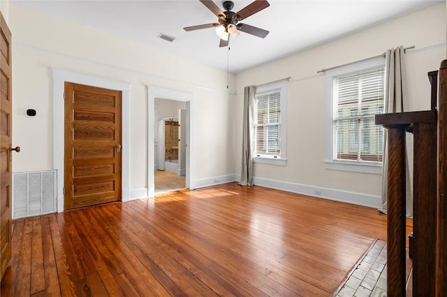 interior space with wood-type flooring and ceiling fan