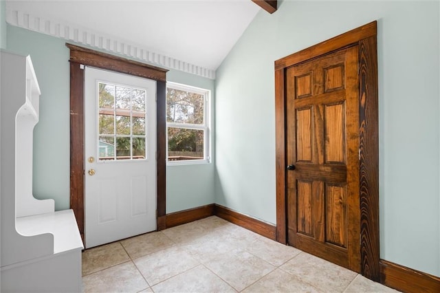 doorway to outside featuring lofted ceiling and light tile patterned floors