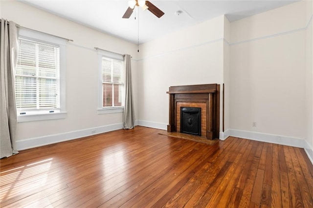 unfurnished living room with wood-type flooring and ceiling fan