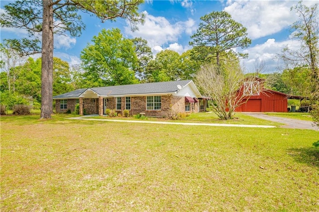 ranch-style home with an outdoor structure and a front yard