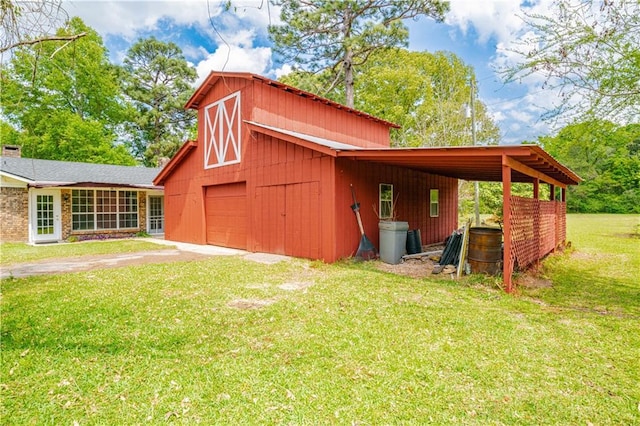 rear view of house featuring a yard, an outbuilding, and a carport