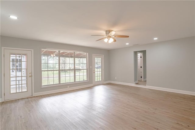 spare room with light wood-type flooring and ceiling fan