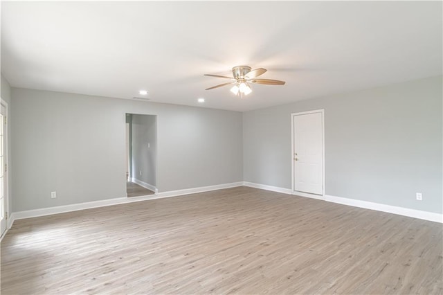 unfurnished room with ceiling fan and light wood-type flooring