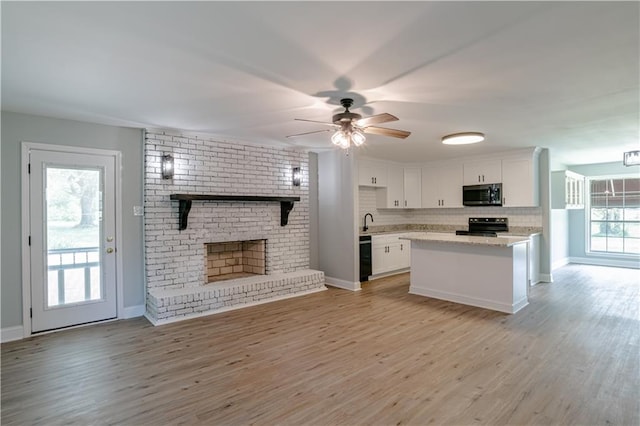 kitchen with decorative backsplash, light wood-type flooring, ceiling fan, black appliances, and white cabinets