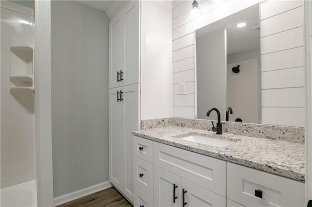 bathroom with vanity and hardwood / wood-style flooring