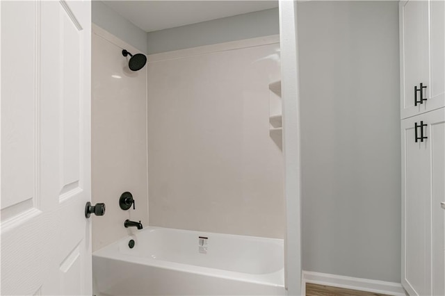 bathroom featuring shower / tub combination and hardwood / wood-style floors