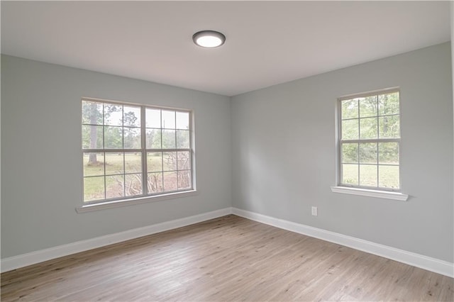 unfurnished room with a wealth of natural light and light hardwood / wood-style flooring