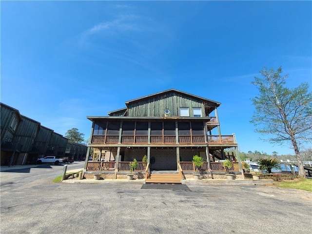 rear view of house featuring a sunroom