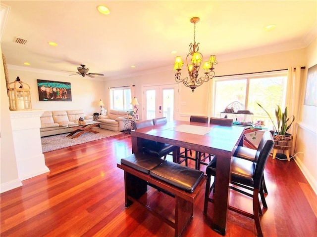 dining room with french doors, ceiling fan with notable chandelier, hardwood / wood-style flooring, and ornamental molding