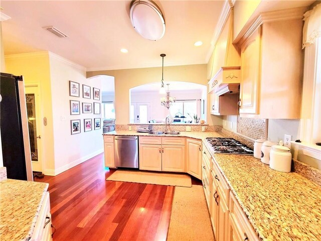 kitchen featuring decorative light fixtures, plenty of natural light, sink, and appliances with stainless steel finishes