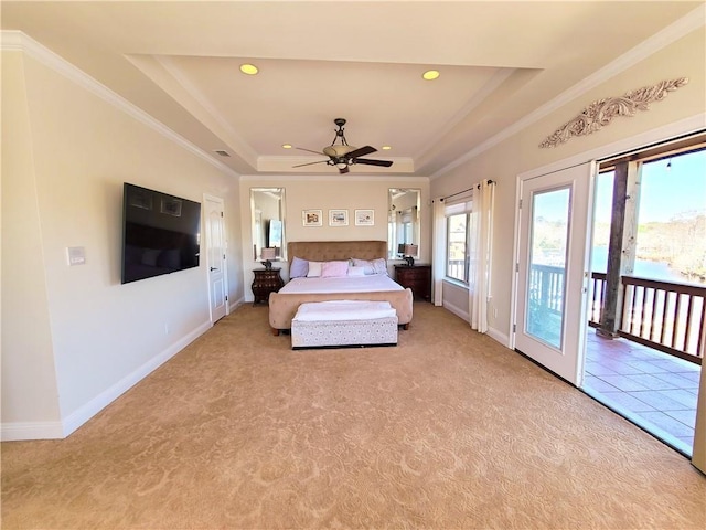 unfurnished bedroom featuring a tray ceiling, access to exterior, light colored carpet, and ornamental molding