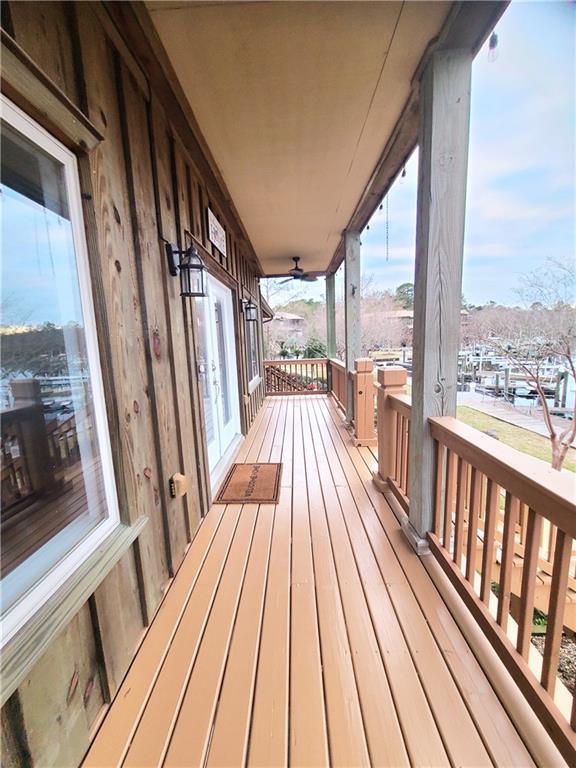 wooden deck with ceiling fan and a porch