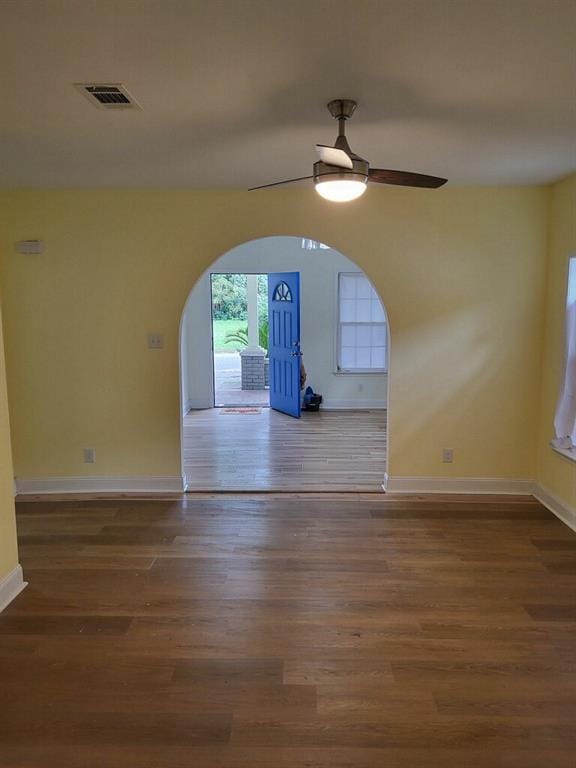 158 Randolph St, Mobile, AL 36607 - unfurnished dining area featuring arched walkways, a ceiling fan, baseboards, wood finished floors, and visible vents