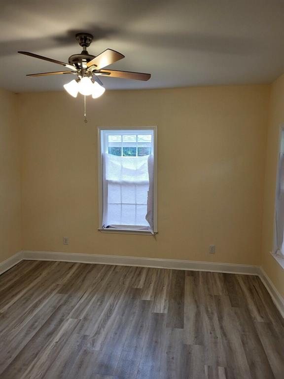 158 Randolph St, Mobile, AL 36607 - unfurnished room with baseboards, ceiling fan, and wood finished floors