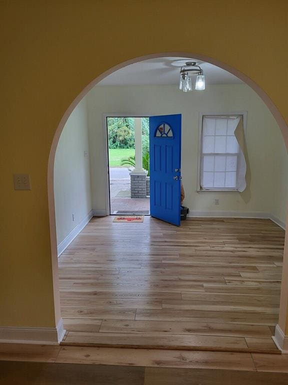 158 Randolph St, Mobile, AL 36607 - entrance foyer with arched walkways, baseboards, and wood finished floors