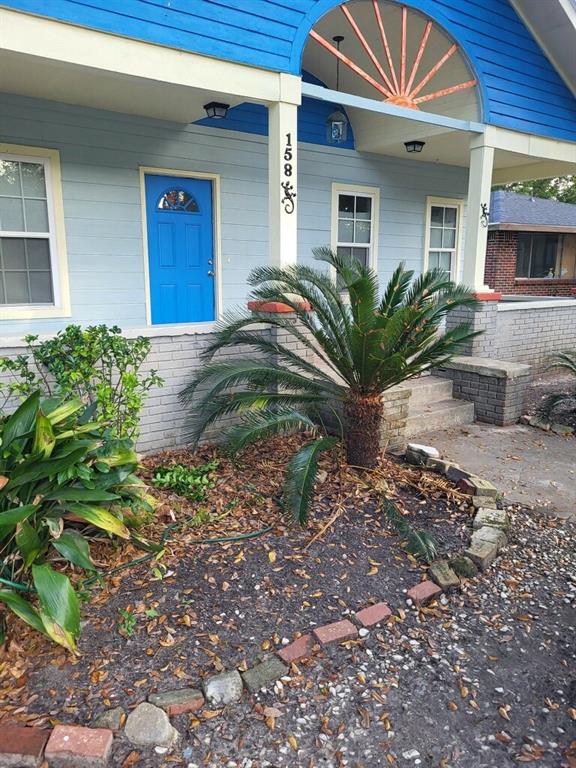 158 Randolph St, Mobile, AL 36607 - doorway to property featuring covered porch and brick siding