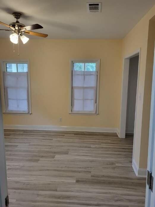 158 Randolph St, Mobile, AL 36607 - unfurnished room featuring baseboards, a ceiling fan, wood finished floors, and visible vents