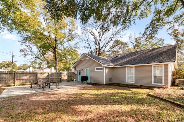 rear view of property with central AC, a yard, and a patio