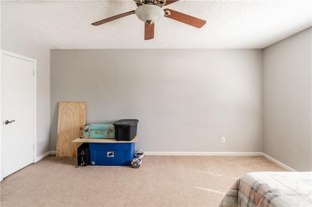 bedroom with carpet, a textured ceiling, and baseboards