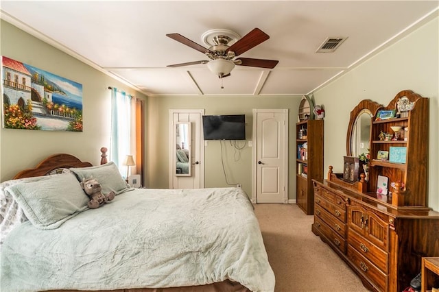 bedroom with ceiling fan, visible vents, and light colored carpet