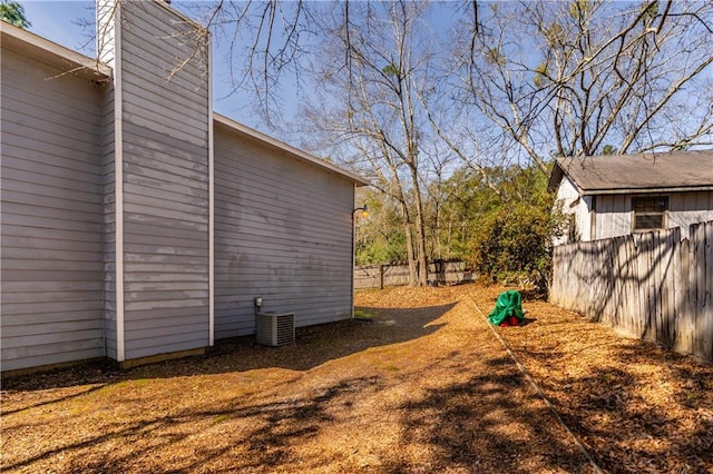 view of yard with fence and cooling unit