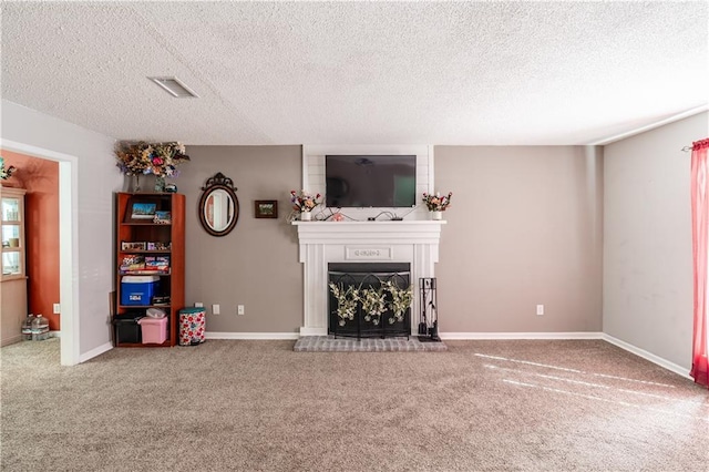 unfurnished living room with baseboards, visible vents, a fireplace with raised hearth, and carpet flooring