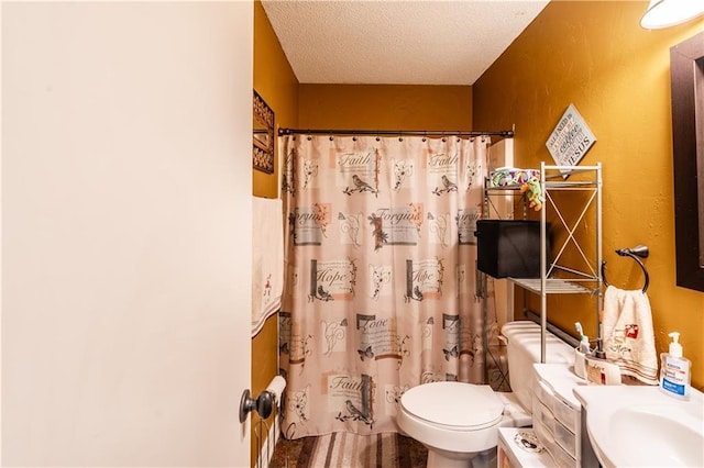 bathroom featuring a textured ceiling, a shower with shower curtain, vanity, and toilet