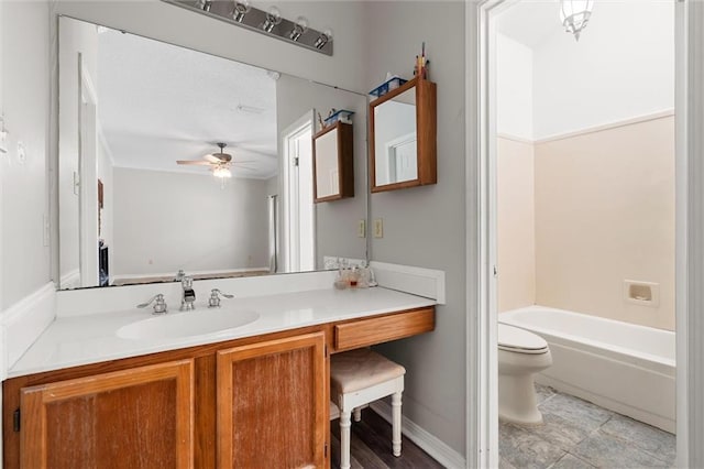 full bathroom with ceiling fan, vanity, toilet, and shower / bathing tub combination