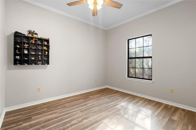 unfurnished room with hardwood / wood-style floors, crown molding, and ceiling fan