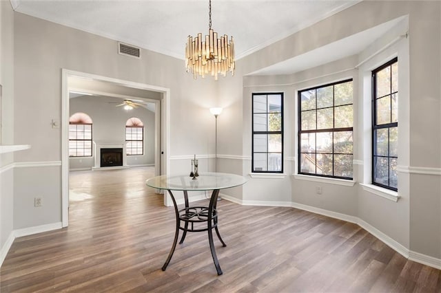 dining room with a healthy amount of sunlight, hardwood / wood-style floors, and a notable chandelier