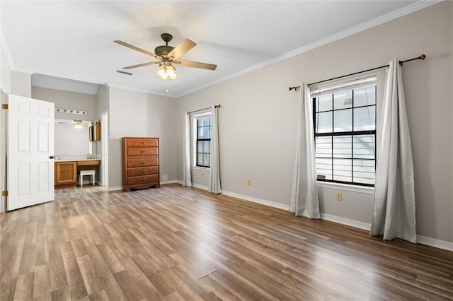 unfurnished bedroom featuring multiple windows, ornamental molding, and ceiling fan