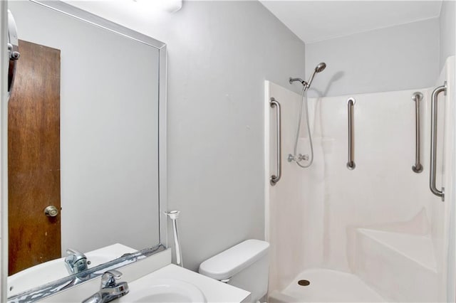 bathroom with sink, walk in shower, and toilet