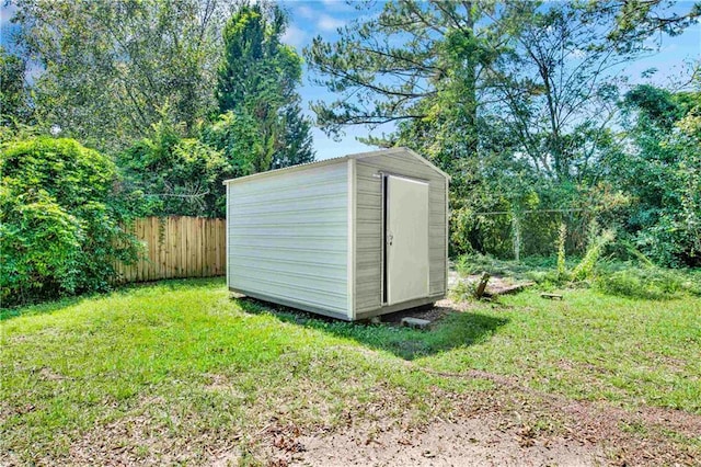 view of outdoor structure featuring a lawn