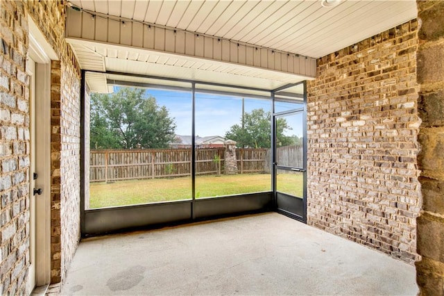 unfurnished sunroom featuring wood ceiling