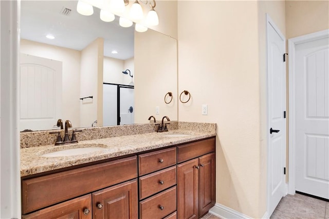 bathroom with tile patterned flooring, vanity, and a shower with door