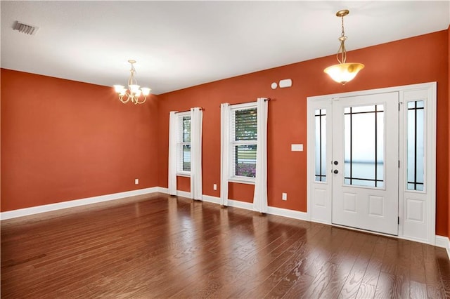 entryway featuring dark hardwood / wood-style floors and an inviting chandelier