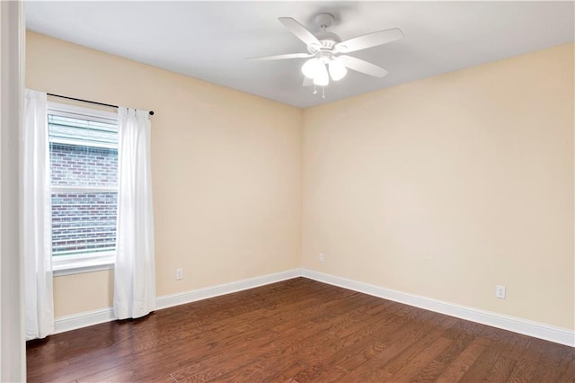 spare room with ceiling fan and dark wood-type flooring