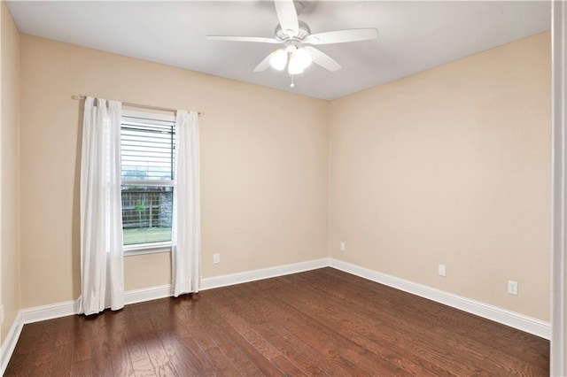 empty room featuring ceiling fan and dark wood-type flooring