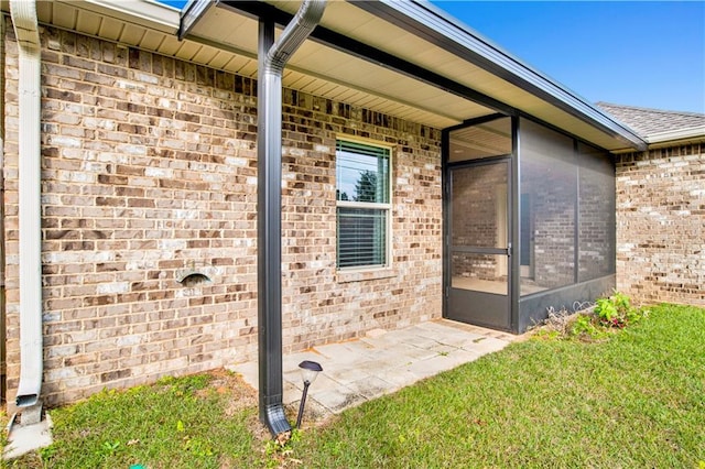 doorway to property featuring a yard