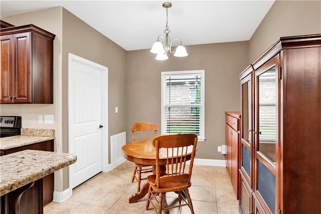 dining space with a chandelier and light tile patterned flooring