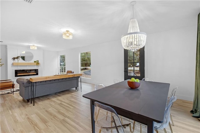 dining space featuring a chandelier and light wood-type flooring